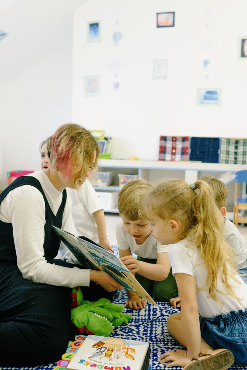 A teacher sharing a picture book with young children